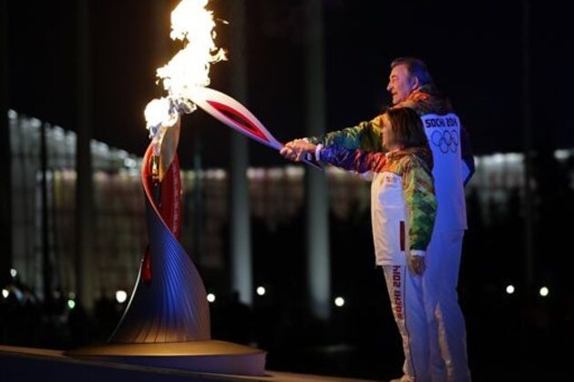 Irina Rodnina and Vladislav Tretiak light the Olympic cauldron during the opening ceremony of the 2014 Winter Olympics in Sochi, Russia, Friday, Feb. 7, 2014. (AP Photo/Matt Slocum, Pool)