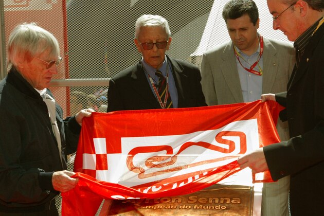 The President of Formula One Management, Bernie Eccleston, left, and the president of the Catalonian Automobile Club RACC, Sebastian Salvadore, 2nd left unviel a plaque in honour of late F1 driver, Brazilian Ayrton Senna in commemoration of the10th anniversary of his death, at the Montmelo circuit on the outskirts of Barcelona, Spain, Saturday May 8, 2004. The Spanish Grand Prix takes place Sunday. Others unideintified. (AP Photo/Bernat Armangue)