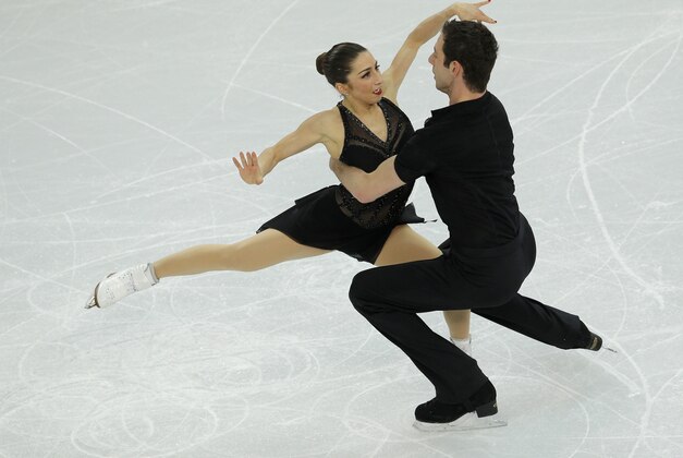 Marissa Castelli and Simon Shnapir of the United States compete in the team pairs short program figure skating competition at the Iceberg Skating Palace during the 2014 Winter Olympics, Thursday, Feb. 6, 2014, in Sochi, Russia. (AP Photo/Vadim Ghirda)