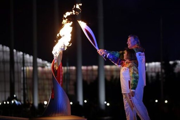Irina Rodnina and Vladislav Tretiak light the Olympic cauldron during the opening ceremony of the 2014 Winter Olympics in Sochi, Russia, Friday, Feb. 7, 2014. (AP Photo/Matt Slocum, Pool)