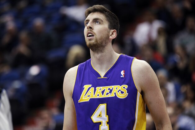 Los Angeles Lakers' Ryan Kelly watches a free throw in an NBA basketball game against the Minnesota Timberwolves, Tuesday, Feb. 4, 2014, in Minneapolis. The Timberwolves won 109-99. (AP Photo/Jim Mone)