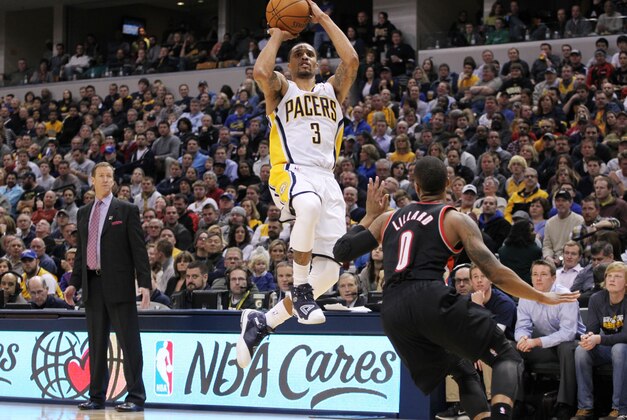 Feb 7, 2014; Indianapolis, IN, USA; Indiana Pacers guard George Hill (3) takes a shot against Portland Trail Blazers guard Damian Lillard (0) at Bankers Life Fieldhouse. Indiana defeats Portland 118-113 in overtime. Mandatory Credit: Brian Spurlock-USA TODAY Sports