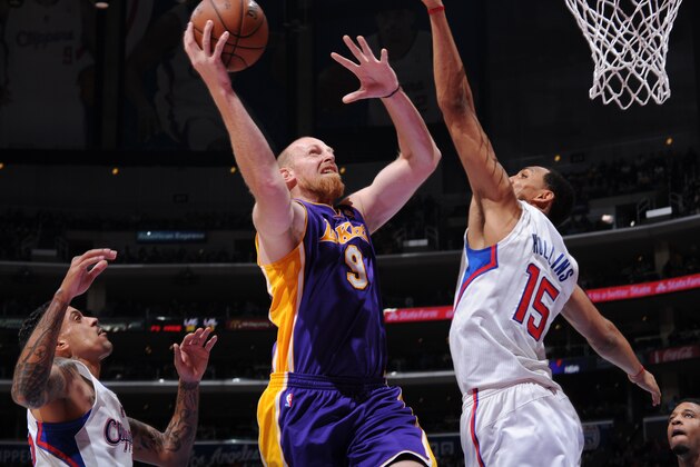 LOS ANGELES, CA - JANUARY 10: Chris Kaman #9 of the Los Angeles Lakers shoots against Ryan Hollins #15 of the Los Angeles Clippers at STAPLES Center on January 10, 2014 in Los Angeles, California. NOTE TO USER: User expressly acknowledges and agrees that, by downloading and/or using this Photograph, user is consenting to the terms and conditions of the Getty Images License Agreement. Mandatory Copyright Notice: Copyright 2014 NBAE (Photo by Andrew D. Bernstein/NBAE via Getty Images)
