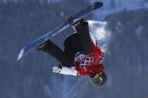 Canada's Maxence Parrot takes a jump during the men's snowboard slopestyle qualifying at the Rosa Khutor Extreme Park ahead of the 2014 Winter Olympics, Thursday, Feb. 6, 2014, in Krasnaya Polyana, Russia.  (AP Photo/Sergei Grits)