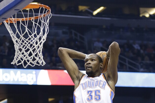 Oklahoma City Thunder's Kevin Durant (35) makes an uncontested dunk against the Orlando Magic during the first half of an NBA basketball game in Orlando, Fla., Friday, Feb. 7, 2014. (AP Photo/John Raoux)