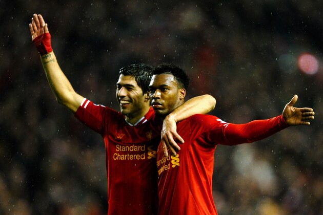 LIVERPOOL, ENGLAND - JANUARY 28:  Daniel Sturridge (R) of Liverpool is congratulated by teammate Luis Suarez (L) after scoring his team's third goal during the Barclays Premier League match between Liverpool and Everton at Anfield on January 28, 2014 in Liverpool, England.  (Photo by Laurence Griffiths/Getty Images)