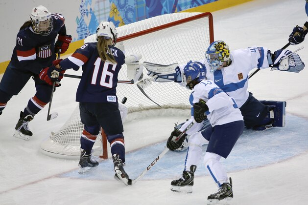 Kelli Stack of the Untied States (16) scores a goal on an assist from Hilary Knight (21) of the Untied States as Goalkeeper Noora Raty of Finland tries to block the shot during the second period of the 2014 Winter Olympics women's ice hockey match at Shayba Arena, Saturday, Feb. 8, 2014, in Sochi, Russia. (AP Photo/David J. Phillip)