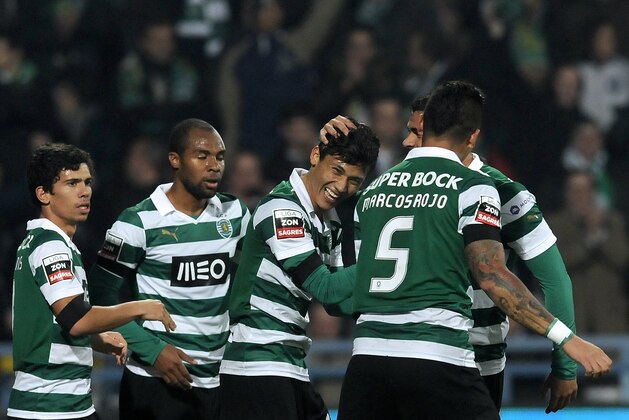 Sporting's Andre Martins, Wilson Eduardo, Fredy Montero from Colombia, Marcos Rojo from Argentina and Mauricio Nascimento from Brazil, from left, celebrate the opening goal against Gil Vicente in a Portuguese League soccer match at the Cidade de Barcelos stadium, Barcelos, northern Portugal, Sunday, Dec. 8, 2013. Montero scored twice in Sporting's 2-0 victory. (AP Photo/Paulo Duarte)