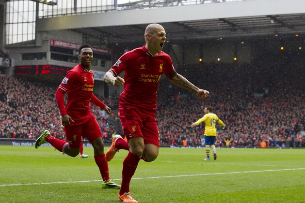 Liverpool's Martin Skrtel, centre, celebrates after scoring his first goal against Arsenal during their English Premier League soccer match at Anfield Stadium, Liverpool, England, Saturday Feb. 8, 2014. (AP Photo/Jon Super)