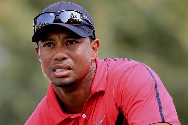 Tiger Woods of the U.S. follows his ball after he tees off at the 14th hole during the final round of the Dubai Desert Classic golf tournament in Dubai, United Arab Emirates, Sunday, Feb. 2, 2014. (AP Photo)