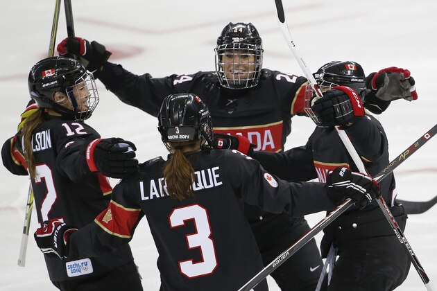Jocelyne Larocque of Canada (3) celebrates with her teammates after scoring a goal against Switzerland in the first period of the women's ice hockey game at the Shayba Arena during the 2014 Winter Olympics, Saturday, Feb. 8, 2014, in Sochi, Russia. (AP Photo/Petr David Josek)