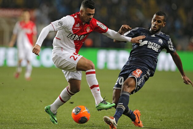 Monaco's Emmanuel Riviere of France, left, challenges Marseille's Jacques Alaixys Romao of Togo for the ball during their French League One soccer match, in Monaco stadium, Sunday Jan. 26, 2014. (AP Photo/Lionel Cironneau)