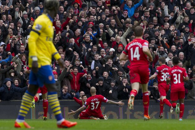 Liverpool's Martin Skrtel, centre, celebrates after scoring his second goal against Arsenal during their English Premier League soccer match at Anfield Stadium, Liverpool, England, Saturday Feb. 8, 2014. (AP Photo/Jon Super)