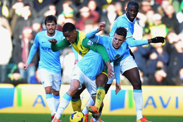 NORWICH, ENGLAND - FEBRUARY 08:  Leroy Fer of Norwich City tackles Stevan Jovetic of Manchester City during the Barclays Premier League match between Norwich City and Manchester City at Carrow Road on February 8, 2014 in Norwich, England.  (Photo by Tony Marshall/Getty Images)