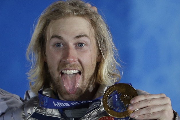 Gold medal winner Sage Kotsenburg, of the United States, holds up his medal during the medal ceremony for the Snowboard Men's Slopestyle competition at the 2014 Winter Olympics, Saturday, Feb. 8, 2014, in Sochi, Russia. (AP Photo/David J. Phillip )