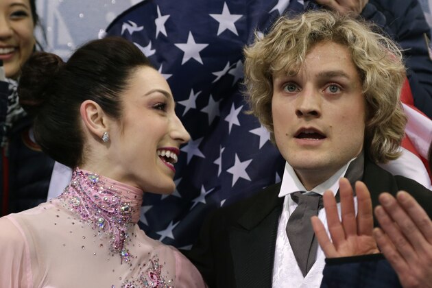 Meryl Davis and Charlie White of the United States wait for their results after competing in the team ice dance short dance figure skating competition at the Iceberg Skating Palace during the 2014 Winter Olympics, Saturday, Feb. 8, 2014, in Sochi, Russia. (AP Photo/Darron Cummings, Pool)