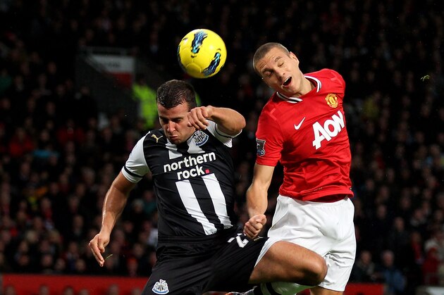 MANCHESTER, ENGLAND - NOVEMBER 26:   Stephen Taylor of Newcastle United goes up for a header with Nemanja Vidic of Manchester United during the Barclays Premier League match between Manchester United and Newcastle United at Old Trafford on November 26, 2011 in Manchester, England. (Photo by Alex Livesey/Getty Images)