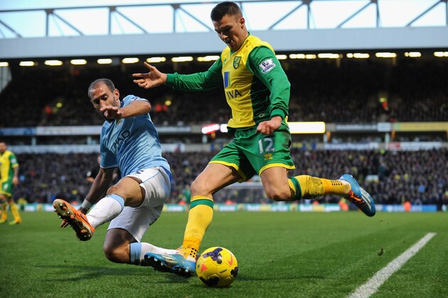 NORWICH, ENGLAND - FEBRUARY 08:  Anthony Pilkington (R) of Norwich City tackled by Pablo Zabaleta of Manchester City during the Barclays Premier League match between Norwich City and Manchester City  at Carrow Road on February 8, 2014 in Norwich, England.  (Photo by Tony Marshall/Getty Images)