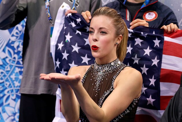 SOCHI, RUSSIA - FEBRUARY 08:  Ashley Wagner of the United States waits for her score with teammates and coaches during the Figure Skating Team Ladies Short Program during day one of the Sochi 2014 Winter Olympics at Iceberg Skating Palace on February 8, 2014 in Sochi, Russia.  (Photo by Darren Cummings/Pool/Getty Images)