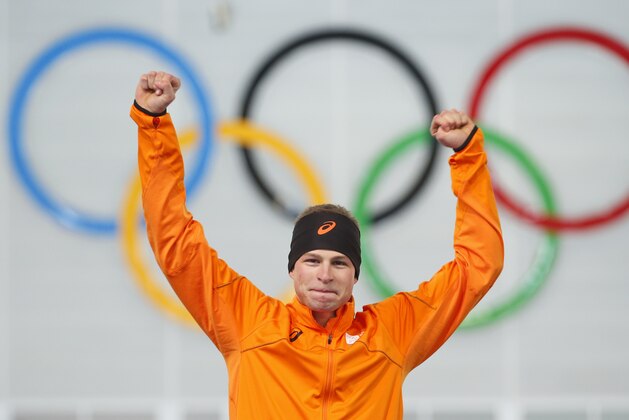 Sven Kramer of the Netherlands celebrates after winning the gold in the men's 5,000-meter speedskating race during the flower ceremony at the Adler Arena Skating Center during the 2014 Winter Olympics in Sochi, Russia, Saturday, Feb. 8, 2014. Kramer set a new Olympic record. (AP Photo/Pavel Golovkin)