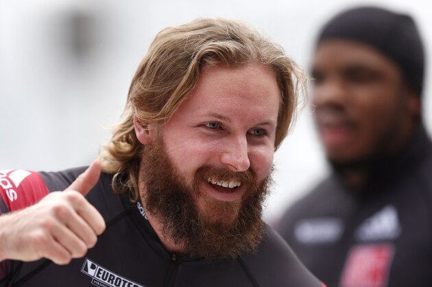 Canada's Justin Kripps, foreground, and Bryan Barnett celebrate after winning their two-man Bobsled World Cup race in Koenigssee, southern Germany, on Saturday, Jan. 25, 2014. (AP Photo/Matthias Schrader)
