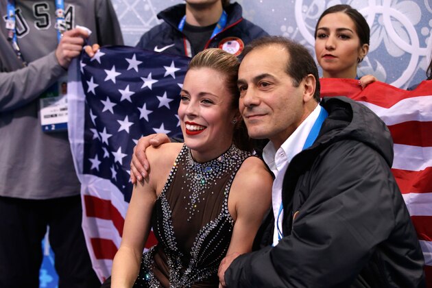 SOCHI, RUSSIA - FEBRUARY 08:  Ashley Wagner of the United States waits for her score with teammates and coaches during the Figure Skating Team Ladies Short Program during day one of the Sochi 2014 Winter Olympics at Iceberg Skating Palace on February 8, 2014 in Sochi, Russia.  (Photo by Darren Cummings/Pool/Getty Images)