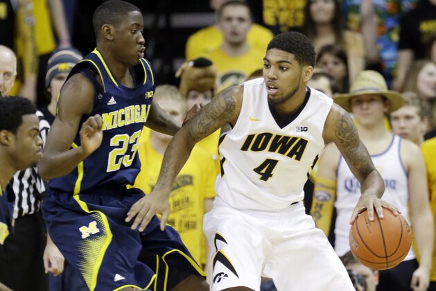 Iowa guard Devyn Marble, right, looks to drive past Michigan guard Caris LeVert (23) during the first half of an NCAA college basketball game, Saturday, Feb. 8, 2014, in Iowa City, Iowa. (AP Photo/Charlie Neibergall)