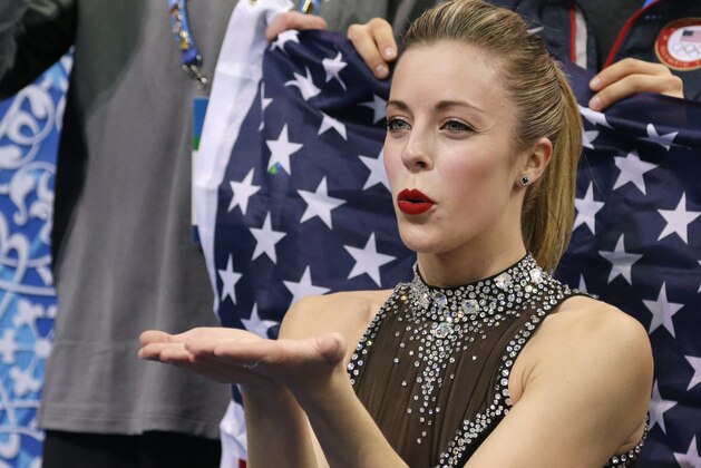 Ashley Wagner of the United States blows a kiss to spectators as she waits for her results after competing in the women's team short program figure skating competition at the Iceberg Skating Palace during the 2014 Winter Olympics, Saturday, Feb. 8, 2014, in Sochi, Russia. (AP Photo/Darron Cummings, Pool)