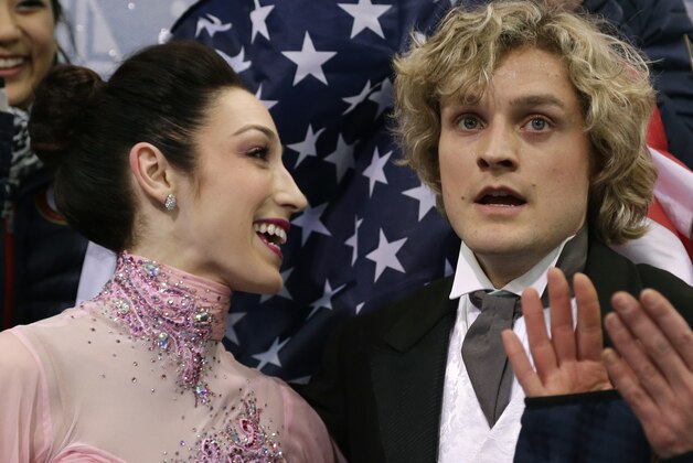 Meryl Davis and Charlie White of the United States wait for their results after competing in the team ice dance short dance figure skating competition at the Iceberg Skating Palace during the 2014 Winter Olympics, Saturday, Feb. 8, 2014, in Sochi, Russia. (AP Photo/Darron Cummings, Pool)