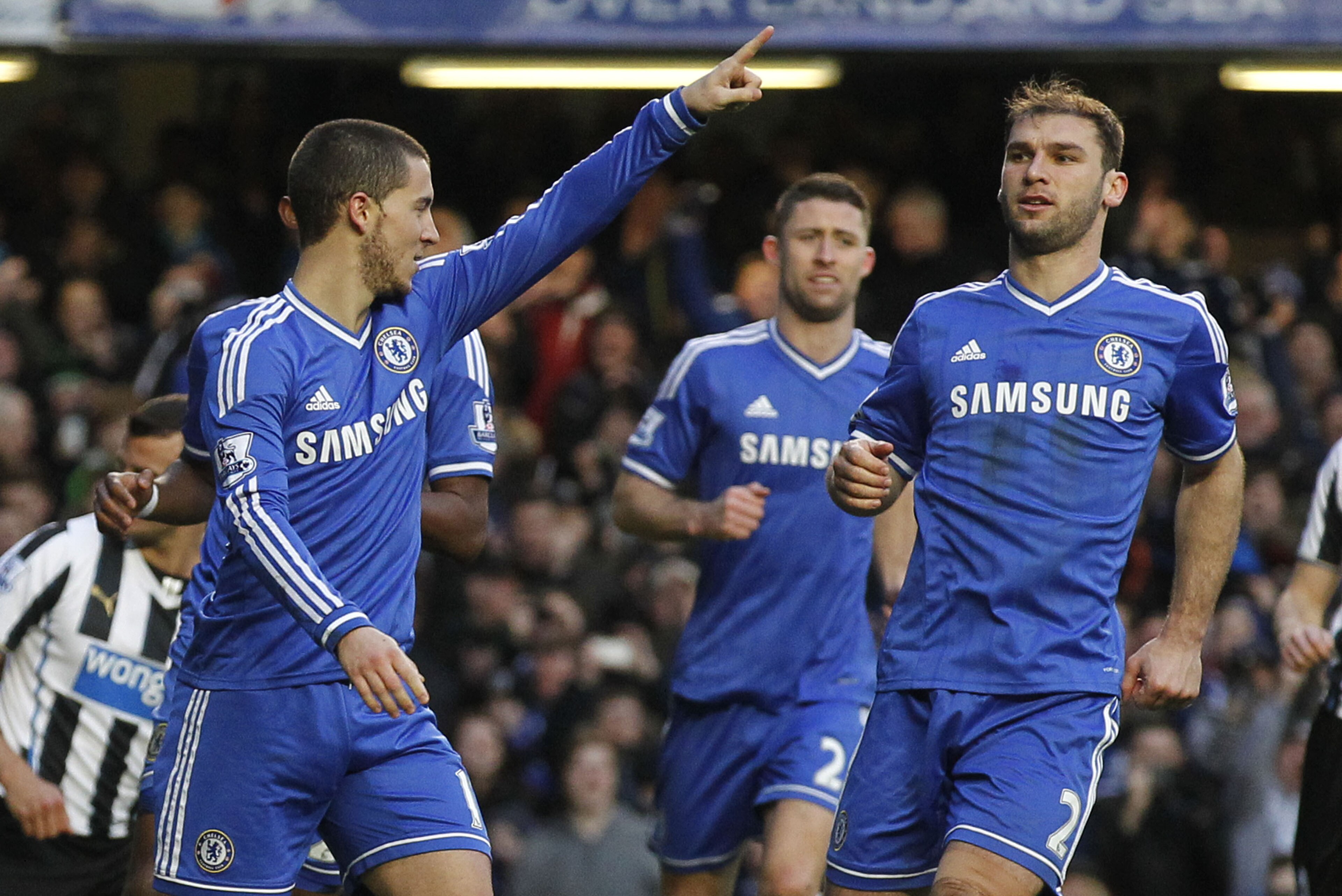 Chelsea's Eden Hazard, left, celebrates his penalty goal against Newcastle United with teammates during their English Premier League soccer match at Stamford Bridge, London, Saturday, Feb. 8, 2014. (AP Photo/Sang Tan)