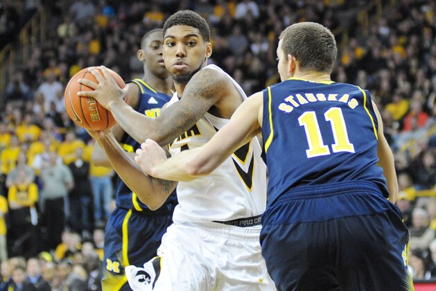 Feb 8, 2014; Iowa City, IA, USA; Iowa Hawkeye guard Roy Devyn Marble (4) drives the lane against Michigan Wolverine guard Nik Stauskas (11) at Carver-Hawkeye Arena. Iowa defeated Michigan 85-67. Mandatory Credit: Steven Branscombe-USA TODAY Sports