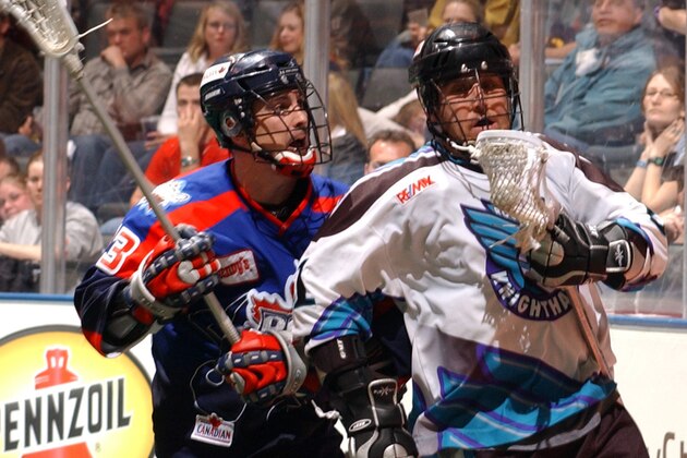 Knighthawk Shawn Williams tries to get away from  Chris Driscoll in the second half of action between the Toronto Rock and Rochester Knighthawks in the NLL East Semi Final game at the Air Canada Centre, in Toronto Ontario Canada. (Photo by B. White/WireImage)