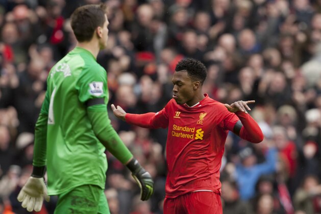 Liverpool's Daniel Sturridge celebrates after scoring past Arsenal's goalkeeper Wojciech Szczesny, left, during their English Premier League soccer match at Anfield Stadium, Liverpool, England, Saturday Feb. 8, 2014. (AP Photo/Jon Super)