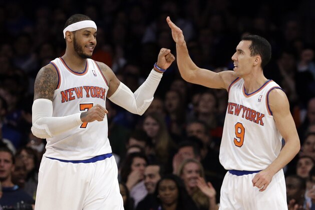 New York Knicks' Carmelo Anthony (7) celebrates with Pablo Prigioni (9) during the second half of an NBA basketball game against the Denver Nuggets on Friday, Feb. 7, 2014, in New York. The Knicks won 117-90. (AP Photo/Frank Franklin II)