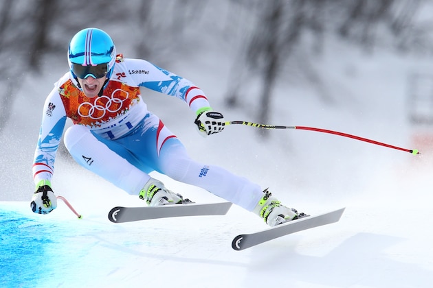 Austria's Matthias Mayer makes a turn in the men's downhill at the Sochi 2014 Winter Olympics, Sunday, Feb. 9, 2014, in Krasnaya Polyana, Russia. (AP Photo/Alessandro Trovati)