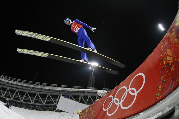 Austria's Michael  Hayboeck makes an attempt in the men's normal hill ski jumping training the 2014 Winter Olympics, Thursday, Feb. 6, 2014, in Krasnaya Polyana, Russia. (AP Photo/Dmitry Lovetsky)