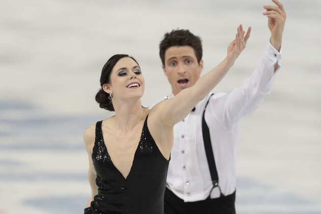 Tessa Virtue and Scott Moir of Canada compete in the team ice dance short dance figure skating competition at the Iceberg Skating Palace during 2014 Winter Olympics, Saturday, Feb. 8, 2014, in Sochi, Russia. (AP Photo/Ivan Sekretarev)