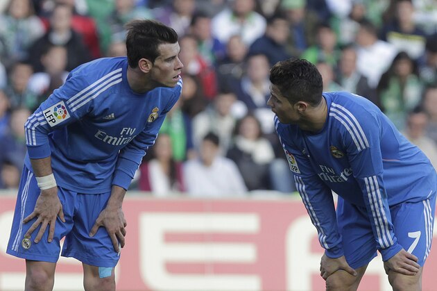 Real Madrid's Cristiano Ronaldo, right, talks with teammate Gareth Bale, left, during their La Liga soccer match against Betis at the Benito Villamarin stadium, in Seville, Spain on Saturday, Jan. 18, 2014. (AP Photo/Angel Fernandez)
