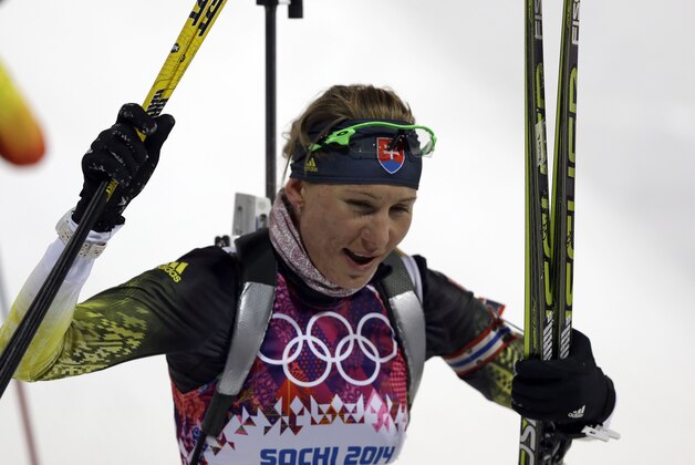 Slovakia's Anastasiya Kuzmina smiles after completing the women's biathlon 7.5k sprint, at the 2014 Winter Olympics, Sunday, Feb. 9, 2014, in Krasnaya Polyana, Russia. (AP Photo/Kirsty Wigglesworth)