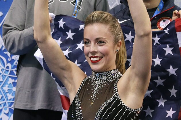 Ashley Wagner of the United States waves to spectators as she waits for her results after competing in the women's team short program figure skating competition at the Iceberg Skating Palace during the 2014 Winter Olympics, Saturday, Feb. 8, 2014, in Sochi, Russia. (AP Photo/Darron Cummings, Pool)