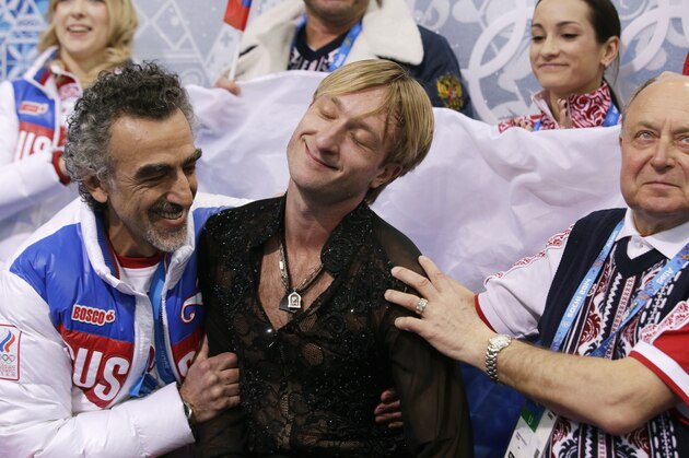 Evgeni Plushenko of Russia, centre, reacts in the results area after competing in the men's team free skate figure skating competition at the Iceberg Skating Palace during the 2014 Winter Olympics, Sunday, Feb. 9, 2014, in Sochi, Russia. (AP Photo/Darron Cummings, Pool)