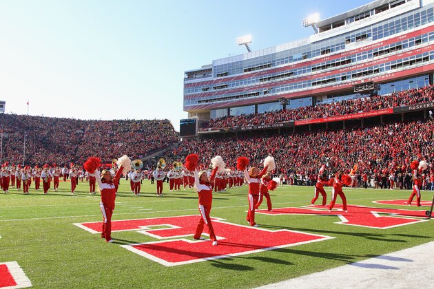 Nebraska cheerleaders and band populate the field prior to the first half of an NCAA college football game against Iowa in Lincoln, Neb., Friday, Nov. 29, 2013. (AP Photo/Nati Harnik)