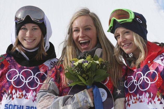 Jamie Anderson of the United States, center, celebrates with silver medalist Enni Rukajarvi of Finland, left,  and bronze medalist  Jenny Jones of Britain, after Anderson won the women's snowboard slopestyle final at the 2014 Winter Olympics, Sunday, Feb. 9, 2014, in Krasnaya Polyana, Russia. (AP Photo/Sergei Grits)