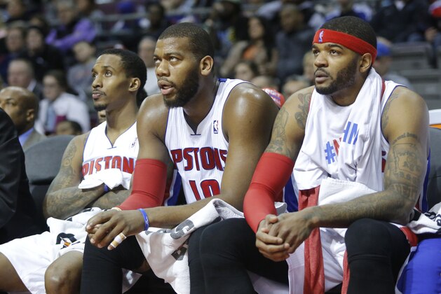 Detroit Pistons guard Brandon Jennings, from left, center Greg Monroe and forward Josh Smith watch their game against the Brooklyn Nets from the bench during the second half of an NBA basketball game Friday, Feb. 7, 2014, in Auburn Hills, Mich. (AP Photo/Duane Burleson)