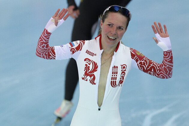 Bronze medallist Olga Graf of Russia celebrates with a wide open front of her skin suit after the women's 3,000-meter speedskating race at the Adler Arena Skating Center during the 2014 Winter Olympics, Sunday, Feb. 9, 2014, in Sochi, Russia. (AP Photo/Pavel Golovkin)