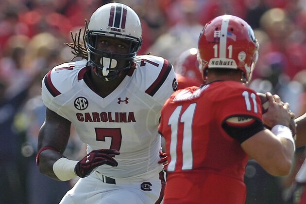 Georgia quarterback Aaron Murray (11) works under pressure from South Carolina defensive end Jadeveon Clowney (7) during the first half of an NCAA football game, Saturday, Sept. 7, 2013, in Athens, Ga. (AP Photo/Mike Stewart)