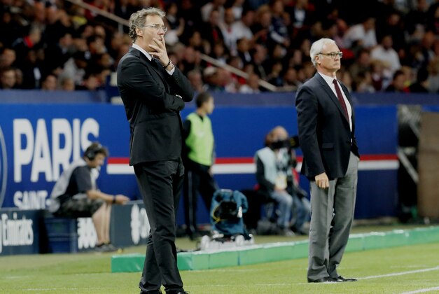 Paris Saint Germain's1 Coach Laurent Blanc, left, with  Monaco's coach,  Claudio Ranieri of Italy, during their  French Premier League soccer match against Monaco during their French League One soccer match, Sunday Sept. 22, 2013, in Parc des Princes stadium, in Paris, France. (AP Photo/Jacques Brinon)