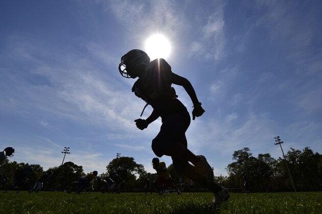 Foreman High School wide receiver Michael Hill lines up during an unofficial practice at Chopin Park, Friday, Sept. 14, 2012 in Chicago. The strike in the nation's third-largest school district could have unintended consequences for Chicago students whose college dreams are tied to their actions on the playing field. (AP Photo/Brian Kersey)