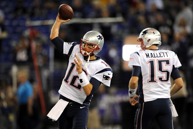 BALTIMORE, MD - SEPTEMBER 23:  Tom Brady #12 of the New England Patriots throws a pass during warms as Ryan Mallett #15 looks on against the Baltimore Ravens at M&T Bank Stadium on September 23, 2012 in Baltimore, Maryland.  (Photo by Patrick Smith/Getty Images)