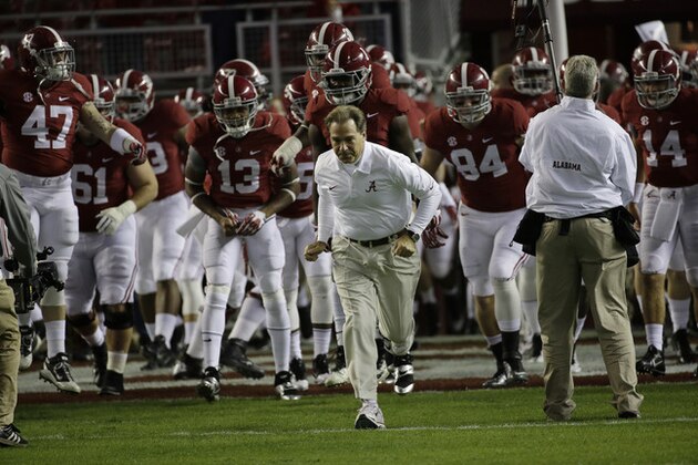 Alabama head coach Nick Saban runs onto the field before the first half of an NCAA college football game against the LSU Tigers, Saturday, Nov. 9, 2013, in Tuscaloosa, Ala. (AP Photo/Dave Martin)